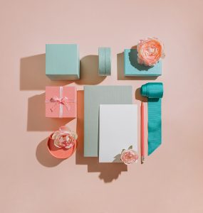 Geometric composition of gift boxes with flowers, mockup for cards, invitations in pastel muted colors. Congratulations on women's day and birthday. Romantic concept layout for wedding invitation