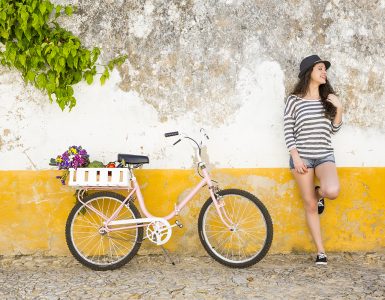 Female tourist living like a local, with her bicycle after buying fresh vegetables