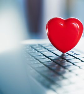 Big red heart on laptop keyboard. Valentine's day holiday concept. Online love, remote communication on internet, social networks. Virtual dating, calls and technology.Quarantine,coronavirus covid-19.