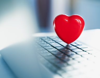 Big red heart on laptop keyboard. Valentine's day holiday concept. Online love, remote communication on internet, social networks. Virtual dating, calls and technology.Quarantine,coronavirus covid-19.